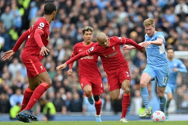 Liverpool's Brazilian midfielder Fabinho (2R) vies with Manchester City's Belgian midfielder Kevin De Bruyne (R) during the English Premier League football match between Manchester City and Liverpool at the Etihad Stadium in Manchester, north west England, on April 10, 2022. The match ended 2-2. PHOTO | AFP