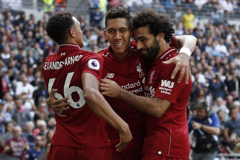 Liverpool's Brazilian midfielder Roberto Firmino (C) celebrates after scoring their second goal with Liverpool's English defender Trent Alexander-Arnold (L) and Liverpool's Egyptian midfielder Mohamed Salah during the English Premier League football match between Tottenham Hotspur and Liverpool at Wembley Stadium in London, on September 15, 2018. PHOTO/AFP