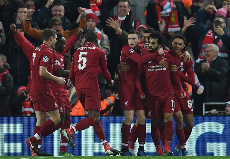 Liverpool's Egyptian midfielder Mohamed Salah (2R) celebrates scoring the opening goal during the UEFA Champions League group C football match between Liverpool and Napoli at Anfield stadium in Liverpool, north west England on December 11, 2018. PHOTO/AFP