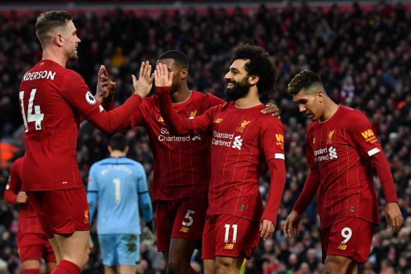 Liverpool's Egyptian midfielder Mohamed Salah (C) celebrates with teammates after scoring his team's third goal during the English Premier League football match between Liverpool and Southampton at Anfield in Liverpool, north west England on February 1, 2020. PHOTO | AFP