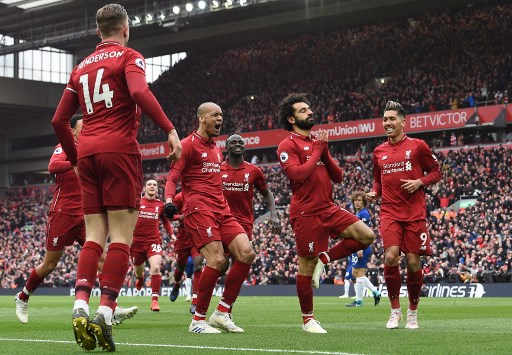 Liverpool's Egyptian midfielder Mohamed Salah (C) celebrates with teammates after scoring their second goal during the English Premier League football match between Liverpool and Chelsea at Anfield in Liverpool, north west England on April 14, 2019. 