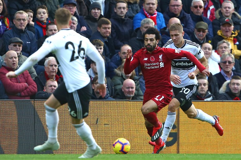 Liverpool's Egyptian midfielder Mohamed Salah (C) vies with Fulham's French defender Maxime Le Marchand (R) and Fulham's English defender Alfie Mawson (L) during the English Premier League football match between Liverpool and Fulham at Anfield in Liverpool, north west England on November 11, 2018. PHOTO/AFP
