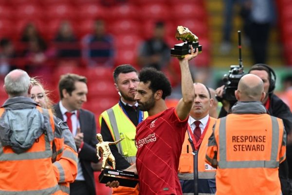 Liverpool's Egyptian midfielder Mohamed Salah celebrates with his two trophies "golden boot" and "playmaker of the year" at the end of the English Premier League football match between Liverpool and Wolverhampton Wanderers at Anfield in Liverpool, north west England on May 22, 2022. Liverpool didn't win the Premier League football title. PHOTO | AFP