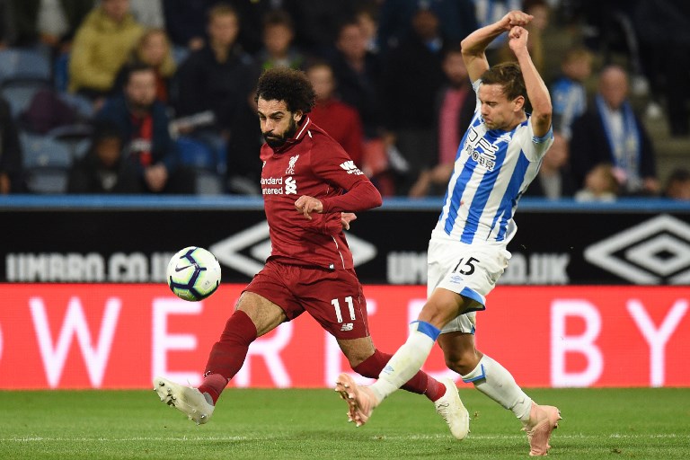 Liverpool's Egyptian midfielder Mohamed Salah has an unsuccessful shot past Huddersfield Town's German defender Chris Lowe (R) during the English Premier League football match between Huddersfield Town and Liverpool at the John Smith's stadium in Huddersfield, northern England on October 20, 2018. PHOTO/AFP