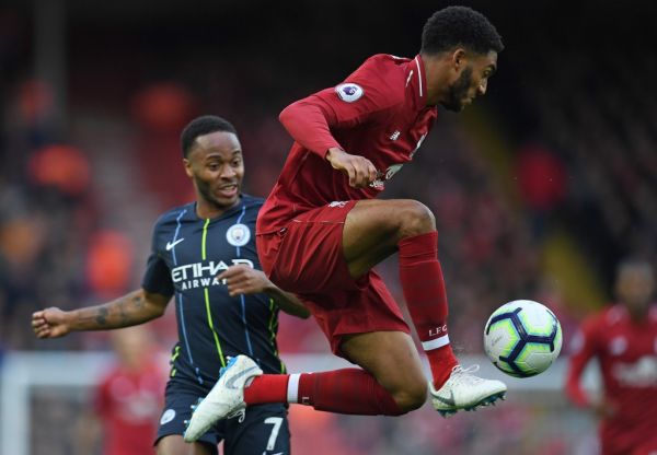 Liverpool's English defender Joe Gomez (R) controls the ball away from the path of Manchester City's English midfielder Raheem Sterling during the English Premier League football match between Liverpool and Manchester City at Anfield in Liverpool, north west England on October 7, 2018. PHOTO | AFP