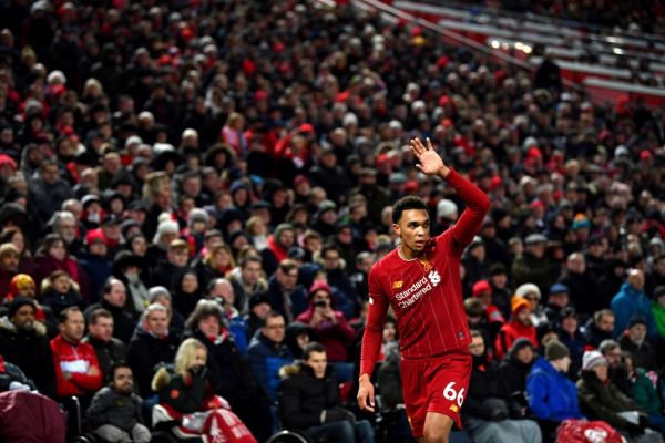 Liverpool's English defender Trent Alexander-Arnold waves to the fans as he leaves the pitch during the English Premier League football match between Liverpool and Brighton and Hove Albion at Anfield in Liverpool, north west England on December 1, 2019. Liverpool won the match 2-1. PHOTO | AFP
