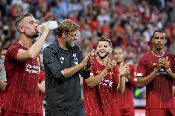 Liverpool's German head coach Jurgen Klopp (2nd L) and his team-players applaud and celebrate at the end of the International friendly football match between Liverpool and Lyon on July 31, 2019 in Geneva. PHOTO | AFP