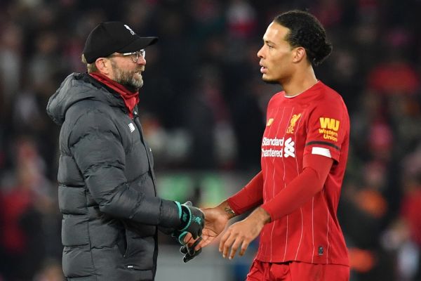 Liverpool's German manager Jurgen Klopp (L) talks with Liverpool's Dutch defender Virgil van Dijk following the English Premier League football match between Liverpool and Brighton and Hove Albion at Anfield in Liverpool, north west England on January 1, 2019. PHOTO | AFP