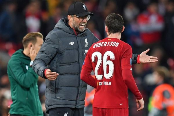 Liverpool's German manager Jurgen Klopp talks with Liverpool's Scottish defender Andrew Robertson (R) during the UEFA Champions league Group E football match between Liverpool and Salzburg at Anfield in Liverpool, north west England on October 2, 2019. PHOTO | AFP