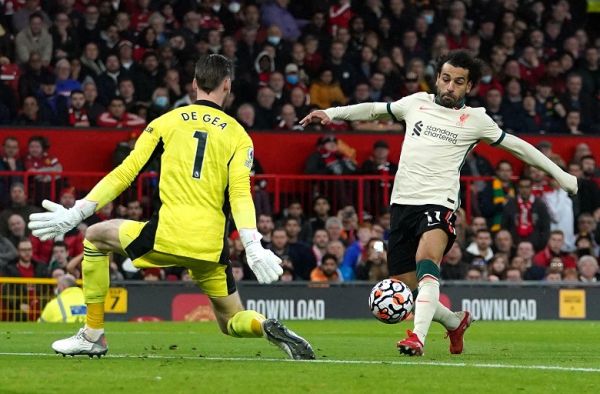 Liverpool's Mohamed Salah (right) scores their side's fifth goal of the game, completing his hat-trick, during the Premier League match at Old Trafford, Manchester.. PHOTO | Alamy