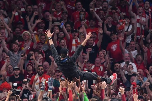 Liverpool's players throw Liverpool's German manager Jurgen Klopp in the air after winning the UEFA Champions League final football match between Liverpool and Tottenham Hotspur at the Wanda Metropolitano Stadium in Madrid on June 1, 2019. PHOTO | AFP