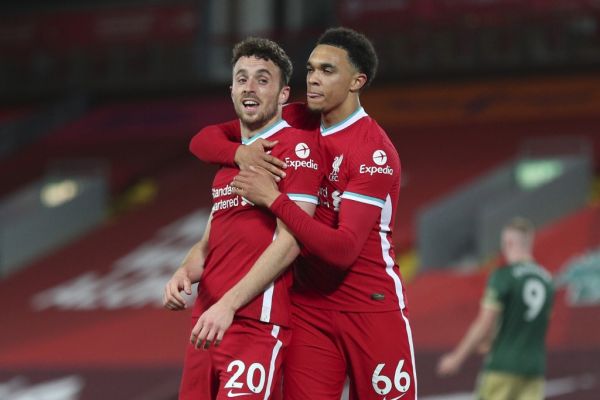 Liverpool's Portuguese striker Diogo Jota (L) celebrates scoring their second goal with Liverpool's English defender Trent Alexander-Arnold (R) during the English Premier League football match between Liverpool and Sheffield United at Anfield in Liverpool, north west England on October 24, 2020. PHOTO | AFP