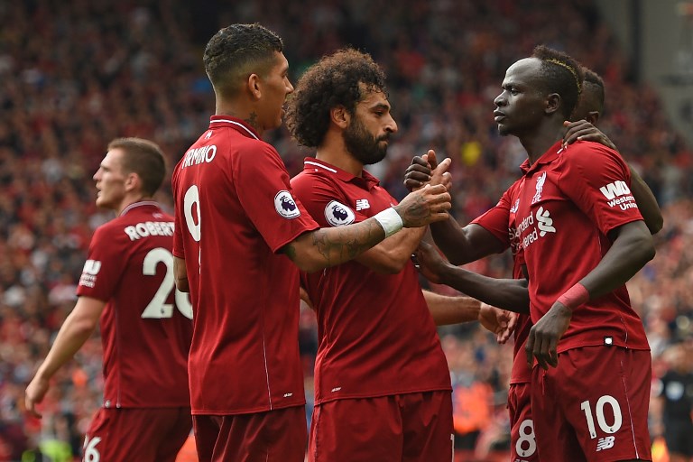 Liverpool's Senegalese striker Sadio Mané (R) celebrates with teammates after scoring their third goal during the English Premier League football match between Liverpool and West Ham United at Anfield in Liverpool, north west England on August 12, 2018. PHOTO/AFP
