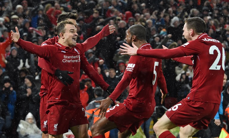 Liverpool's Swiss midfielder Xherdan Shaqiri (L) celebrates with teammates after scoring their second goal during the English Premier League football match between Liverpool and Manchester United at Anfield in Liverpool, north west England on December 16, 2018. PHOTO/AFP