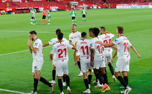 Lucas Ocampos of Sevilla celebrates after his goal with teammates during the Spanish championship Liga football match between Sevilla FC and Real Betis Balompie on June 11, 2020 at Ramon Sanchez Pizjuan stadium in Sevilla, Spain. PHOTO | AFP