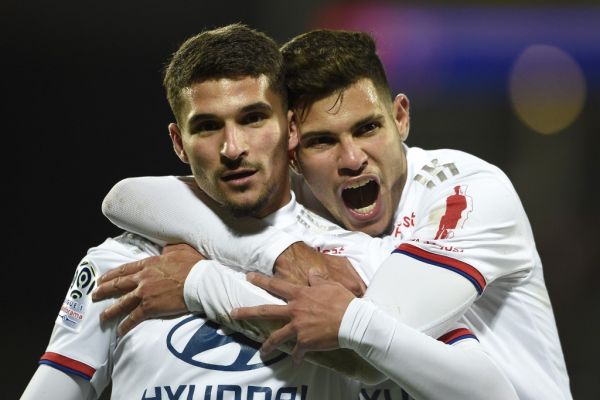 Lyon's French midfielder Houssem Aouar (L) celebrates after scoring a goal during the French L1 football match between Metz (FC Metz) and Lyon (OL) at Saint Symphorien stadium in Longeville-lès-Metz, eastern France, on February 21, 2020. PHOTO | AFP