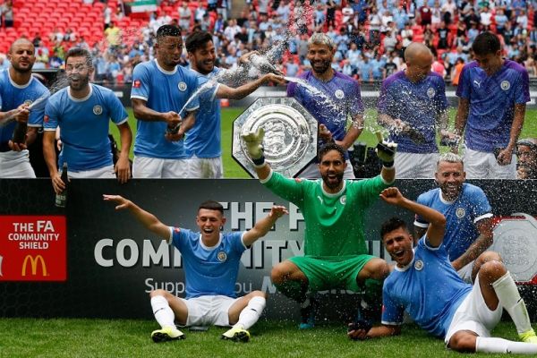 Manchester City players celebrate with the trophy during the presentation after winning the English FA Community Shield football match between Manchester City and Liverpool at Wembley Stadium in north London on August 4, 2019. PHOTO | AFP