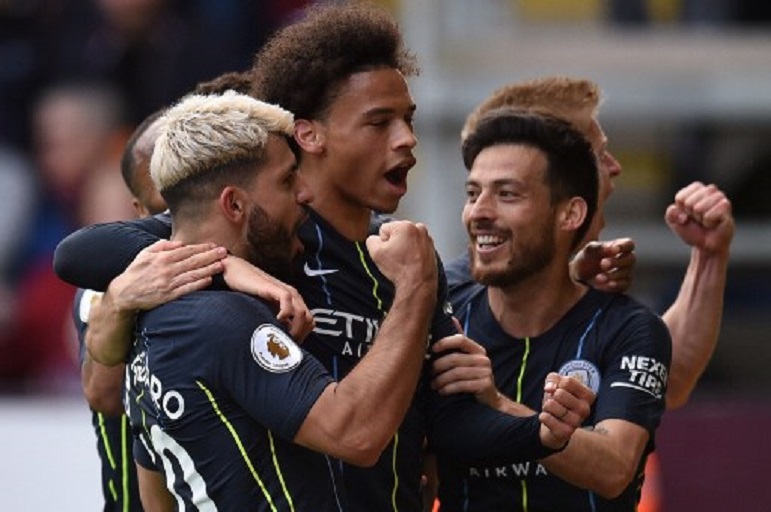 Manchester City's Argentinian striker Sergio Aguero (L) celebrates scoring the opening goal with Manchester City's German midfielder Leroy Sane (2L) and Manchester City's Spanish midfielder David Silva (R) during the English Premier League football match between Burnley and Manchester City at Turf Moor in Burnley, north west England on April 28, 2019. PHOTO/AFP