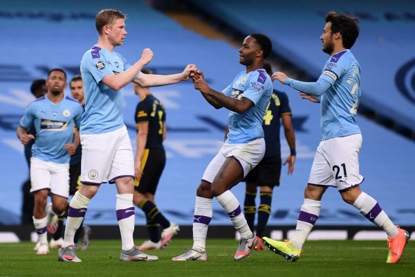 Manchester City's Belgian midfielder Kevin De Bruyne (2L) celebrates scoring his team's second goal from the penalty spot with Manchester City's English midfielder Raheem Sterling (2R) and Manchester City's Spanish midfielder David Silva during the English Premier League football match between Manchester City and Arsenal at the Etihad Stadium in Manchester, north west England, on June 17, 2020. The Premier League makes its eagerly anticipated return today after 100 days in lockdown but behind closed doors due to coronavirus restrictions. PHOTO | AFP