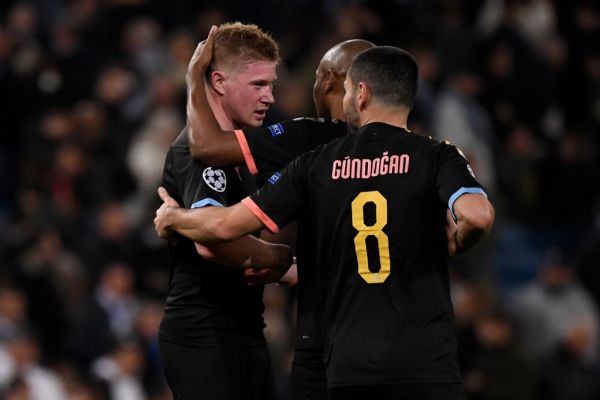 Manchester City's Belgian midfielder Kevin De Bruyne (L) and teammates celebrate their win at the end of the UEFA Champions League round of 16 first-leg football match between Real Madrid CF and Manchester City at the Santiago Bernabeu stadium in Madrid on February 26, 2020. PHOTO | AFP