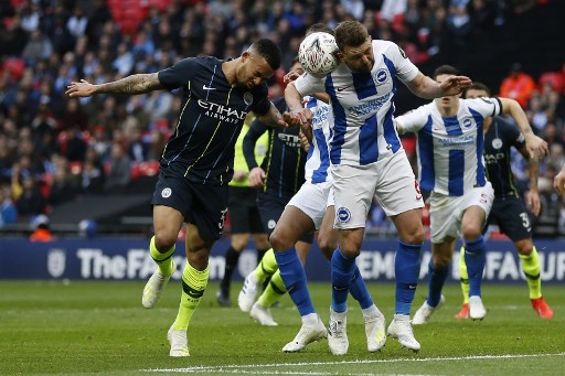 Manchester City's Brazilian striker Gabriel Jesus (L) vies with Brighton's English midfielder Dale Stephens during the English FA Cup semi-final football match between Manchester City and Brighton and Hove Albion at Wembley Stadium in London, on April 6, 2019. PHOTO/AFP