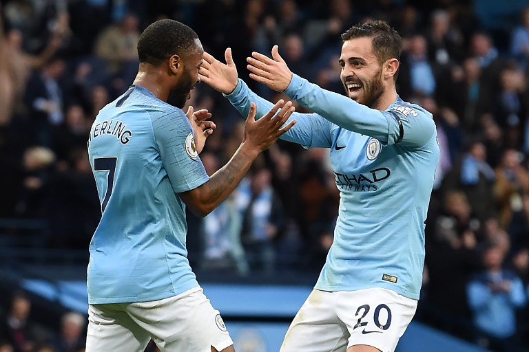 Manchester City's English midfielder Raheem Sterling (L) celebrates with Manchester City's Portuguese midfielder Bernardo Silva (R) after scoring their fourth goal during the English Premier League football match between Manchester City and Southampton at the Etihad Stadium in Manchester, north west England, on November 4, 2018. PHOTO/AFP