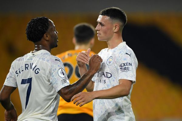 Manchester City's English midfielder Raheem Sterling (L) congratulates Manchester City's English midfielder Phil Foden (R) after he celebrates scoring his team's second goal during the English Premier League football match between Wolverhampton Wanderers and Manchester City at the Molineux stadium in Wolverhampton, central England on September 21, 2020. PHOTO | AFP