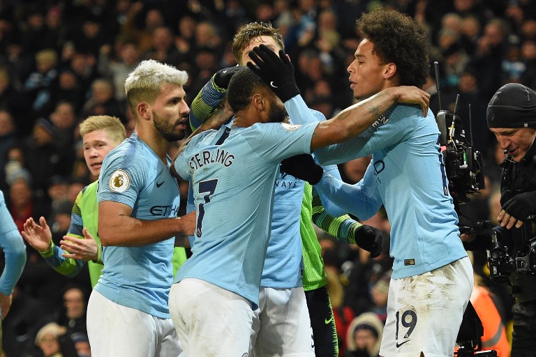 Manchester City's German midfielder Leroy Sane (R) celebrates with teammates after scoring their second goal during the English Premier League football match between Manchester City and Liverpool at the Etihad Stadium in Manchester, north west England, on January 3, 2019.