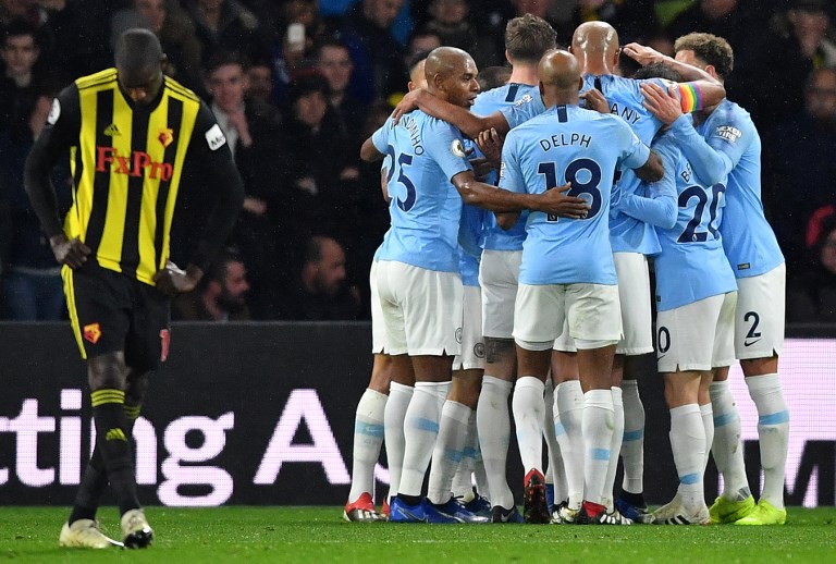 Manchester City's German midfielder Leroy Sane is mobbed by teammates after scoring the opening goal during the English Premier League football match between Watford and Manchester City at Vicarage Road Stadium in Watford, north of London on December 4, 2018. PHOTO/AFP