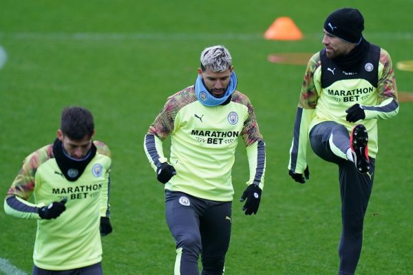 Manchester City's Spanish midfielder David Silva (L), Manchester City's Argentinian striker Sergio Aguero (C) and Manchester City's Argentinian defender Nicolas Otamendi react during a team training session at City Football Academy in Manchester, north west England on February 25, 2020, on the eve of their UEFA Champions League round of 16 first leg football match against Real Madrid. PHOTO | AFP