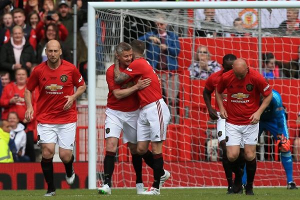 Manchester United '99 Legends player Ole Gunnar Solskjaer (2nd L) celebrates after scoring the opening goal during the Treble Reunion 20th anniversary football match between Manchester United '99 Legends and FC Bayern Legends at Old Trafford in Manchester, north-west England on May 26, 2019. PHOTO | AFP