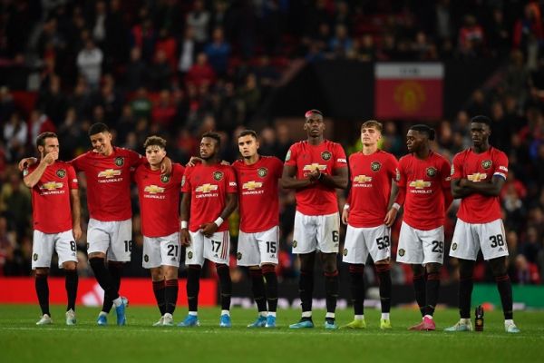 Manchester United player wait in the centre circle as penalties are taken after the game finishes 1-1 during the English League Cup third round football match between Manchester United and Rochdale at Old Trafford in Manchester, north-west England on September 25, 2019. PHOTO | AFP