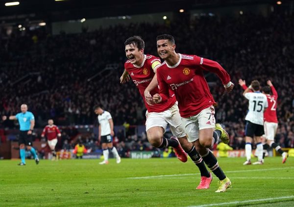 Manchester United's Cristiano Ronaldo (second left) celebrates scoring their side's third goal of the game with Harry Maguire during the UEFA Champions League, Group F match at Old Trafford, Manchester. PHOTO | Alamy