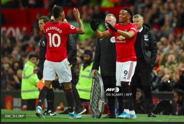 Manchester United's English striker Marcus Rashford (L) is substituted for Manchester United's French striker Anthony Martial (R) during the English Premier League football match between Manchester United and Liverpool at Old Trafford in Manchester, north west England, on October 20, 2019. PHOTO | AFP