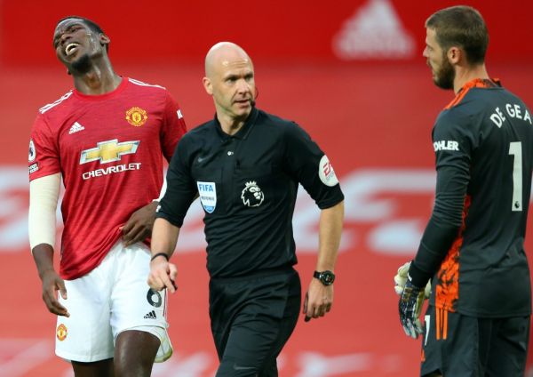 Manchester United's French midfielder Paul Pogba (L) after a foul on Tottenham Hotspur's Welsh defender Ben Davies (unseen) giving away a penalty during the English Premier League football match between Manchester United and Tottenham Hotspur at Old Trafford in Manchester, north west England, on October 4, 2020. PHOTO | AFP