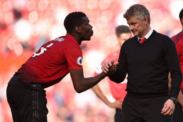 Manchester United's French midfielder Paul Pogba (L) shakes hands with Manchester United's Norwegian manager Ole Gunnar Solskjaer (R) on the pitch after the English Premier League football match between Manchester United and Cardiff City at Old Trafford in Manchester, north west England, on May 12, 2019. Cardiff won the game 2-0. PHOTO | AFP