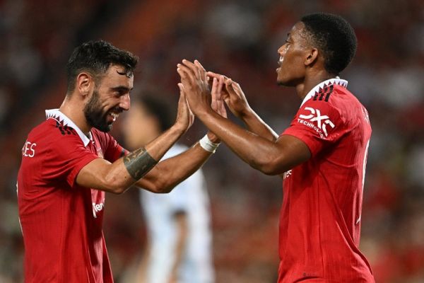 Manchester United's French striker Anthony Martial (R) and Manchester United's Portuguese midfielder Bruno Fernandes celebrate during the exhibition football match between English Premier League teams Manchester United and Liverpool FC at Rajamangala National Stadium in Bangkok on July 12, 2022. PHOTO | AFP