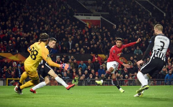 Manchester United's striker Mason Greenwood (2nd R) shoots to score the opening goal past FK Partizan's Serbian goalkeeper Vladimir Stojkovic (L) during the UEFA Europa League Group L football match between Manchester United and Partizan Belgrade at Old Trafford in Manchester, north west England, on November 7, 2019. PHOTO | AFP