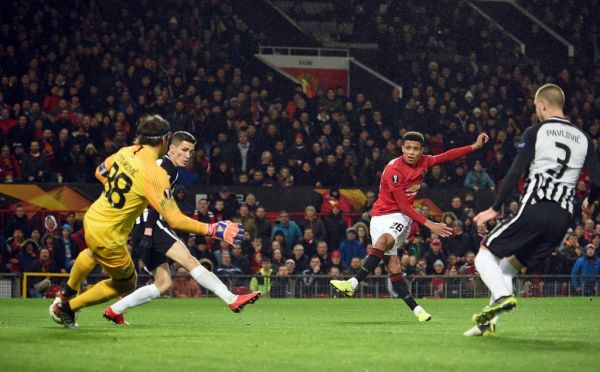 Manchester United's striker Mason Greenwood (2nd R) shoots to score the opening goal past FK Partizan's Serbian goalkeeper Vladimir Stojkovic (L) during the UEFA Europa League Group L football match between Manchester United and Partizan Belgrade at Old Trafford in Manchester, north west England, on November 7, 2019.  PHOTO | AFP