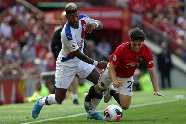 Manchester United's Welsh midfielder Daniel James (R) vies with Crystal Palace's Dutch defender Patrick van Aanholt (L) during the English Premier League football match between Manchester United and Crystal Palace at Old Trafford in Manchester, north west England, on August 24, 2019. PHOTO | AFP