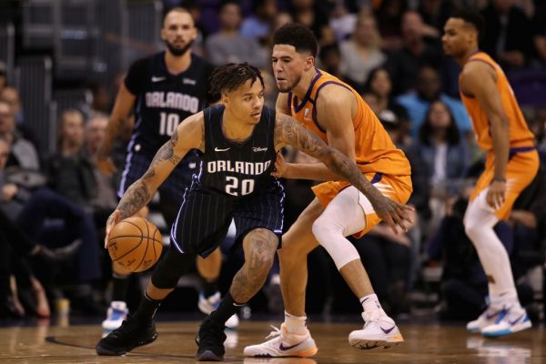 Markelle Fultz #20 of the Orlando Magic drives the ball past Devin Booker #1 of the Phoenix Suns during the second half of the NBA game at Talking Stick Resort Arena on January 10, 2020 in Phoenix, Arizona. The Suns defeated the Magic 98-94. PHOTO \ AFP