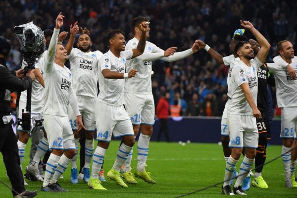 Marseille players celebrate at the end of the French L1 football match between Olympique de Marseille (OM) and Olympique Lyonnais (OL) on November 10, 2019 at the Orange Velodrome stadium in Marseille, southeastern France. PHOTO | AFP