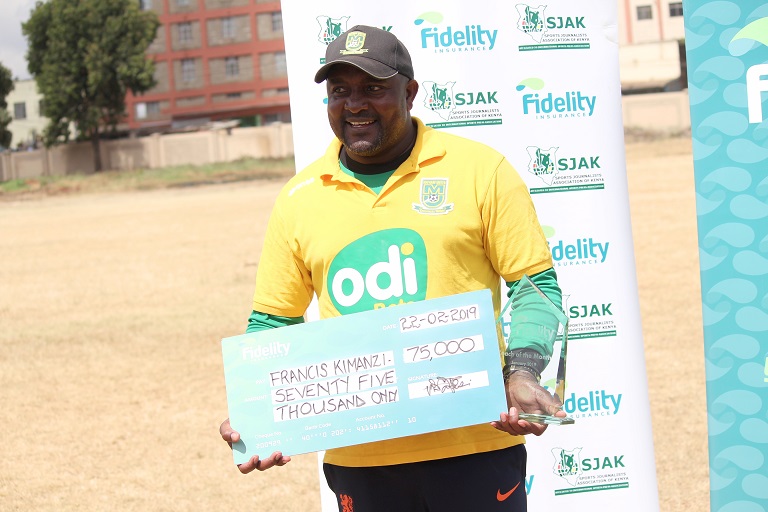 Mathare United Coach Francis Kimanzi (left) is presented with the Fidelity Insurance Coach of the Month gong by the company's Marketing Manager Nicholas Malesi at Goan institute. PHOTO/SJAK