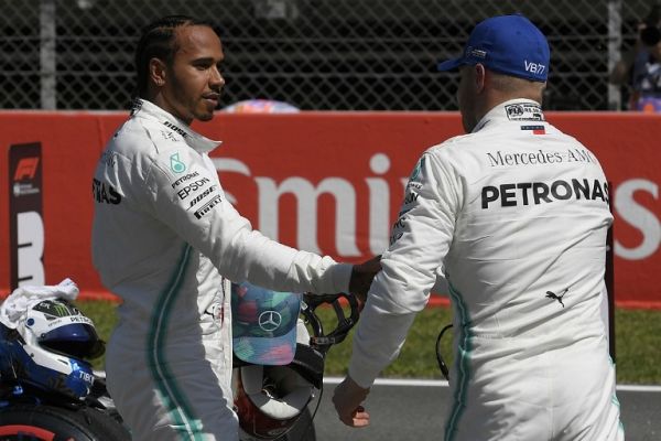 Mercedes' British driver Lewis Hamilton (L) congratulates Mercedes' Finnish driver Valtteri Bottas after he secured the pole position following the qualifying session at the Circuit de Catalunya in Montmelo in the outskirts of Barcelona on May 11, 2019 ahead of the Spanish Formula One Grand Prix. PHOTO/AFP