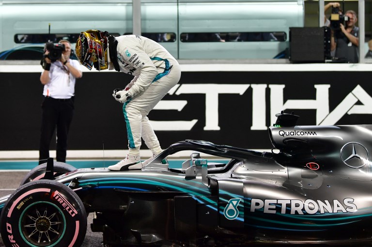 Mercedes' British driver Lewis Hamilton celebrates after taking the pole position in the qualifying session at the Yas Marina circuit on November 24, 2018, in Abu Dhabi, ahead of the Abu Dhabi Formula One Grand Prix.PHOTO/ AFP
