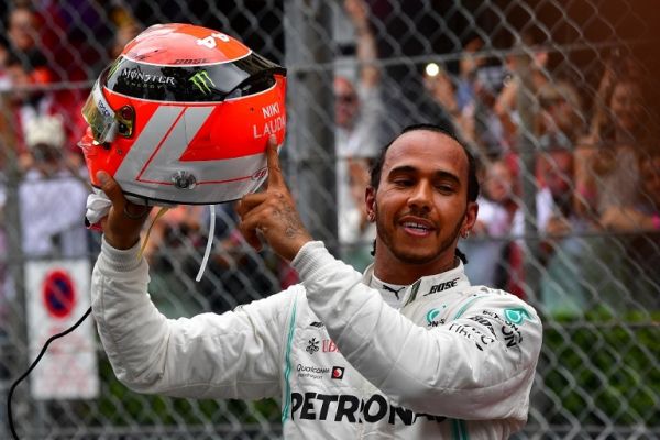 Mercedes' British driver Lewis Hamilton points at the name of late Formula One legend Niki Lauda on his helmet after winning the Monaco Formula 1 Grand Prix at the Monaco street circuit on May 26, 2019 in Monaco. PHOTO | AFP