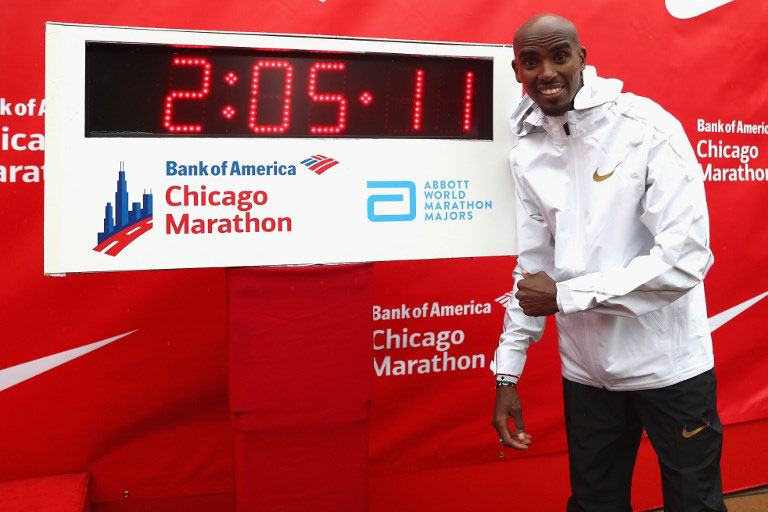Mohammed Farah poses next to a digital clock displaying his winning time from the 2018 Chicago Marathon in October. PHOTO/AFP