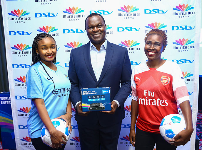 MultiChoice Kenya Managing Director, Eric Odipo, poses with models at the launch of DStv New Football Season at a Nairobi hotel on August 7, 2018.PHOTO/SPN