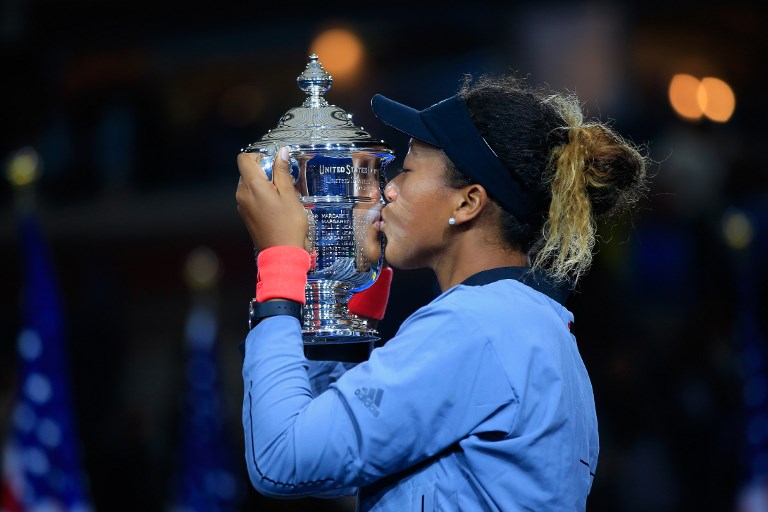 Naomi Osaka of Japan kisses the championship trophy after winning the Women's Singles finals match against Serena Williams of the United States on Day Thirteen of the 2018 US Open at the USTA Billie Jean King National Tennis Center on September 8, 2018 in the Flushing neighborhood of the Queens borough of New York City. PHOTO/AFP