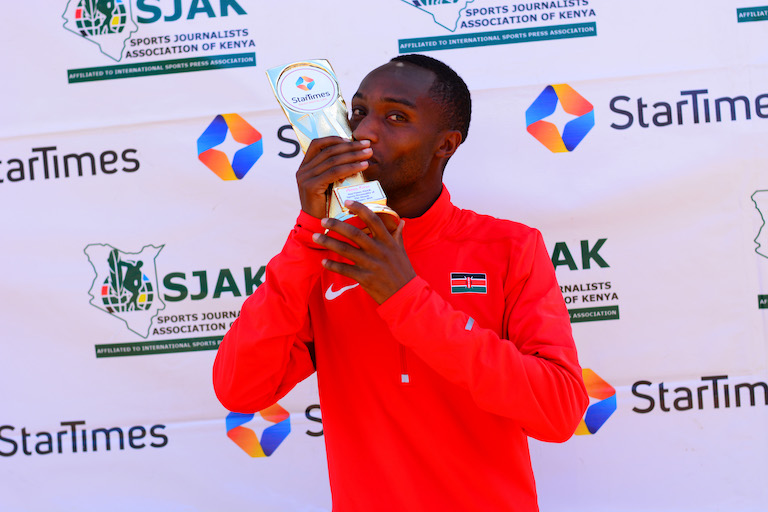 National cross country champion Amos Kirui savours the moment with his SPOM Trophy for February 2019 at Siwot, Keringet Town,Nakuru County. PHOTO/Courtesy